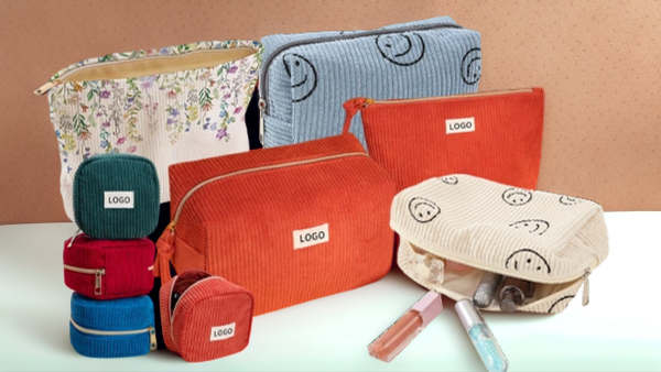 Range of corduroy cosmetic pouches in multiple colors with an embroidered brand logo