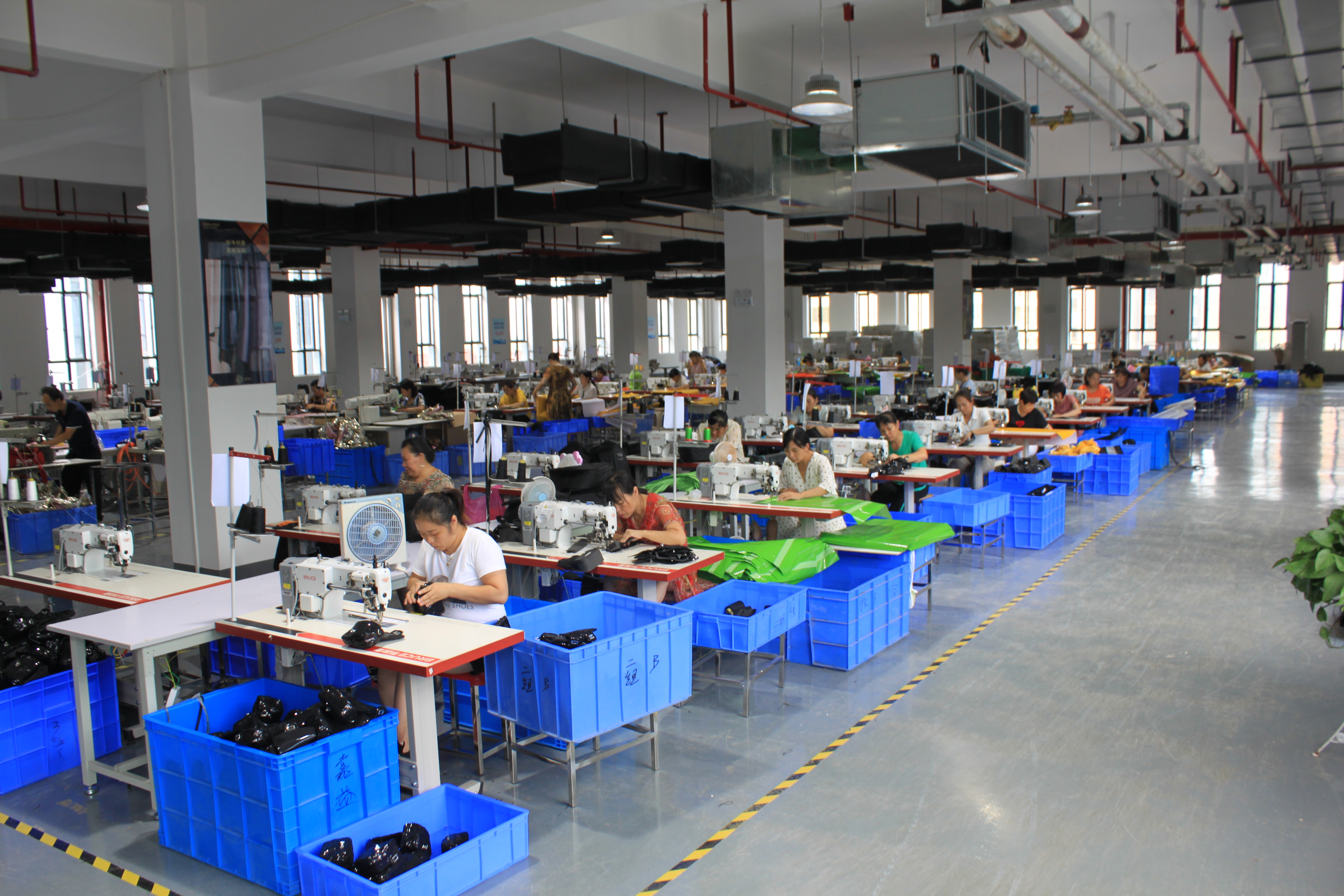 Rows of industrial sewing stations at FUYUAN Shenzhen cosmetic bag factory producing custom makeup bags for Amazon brands